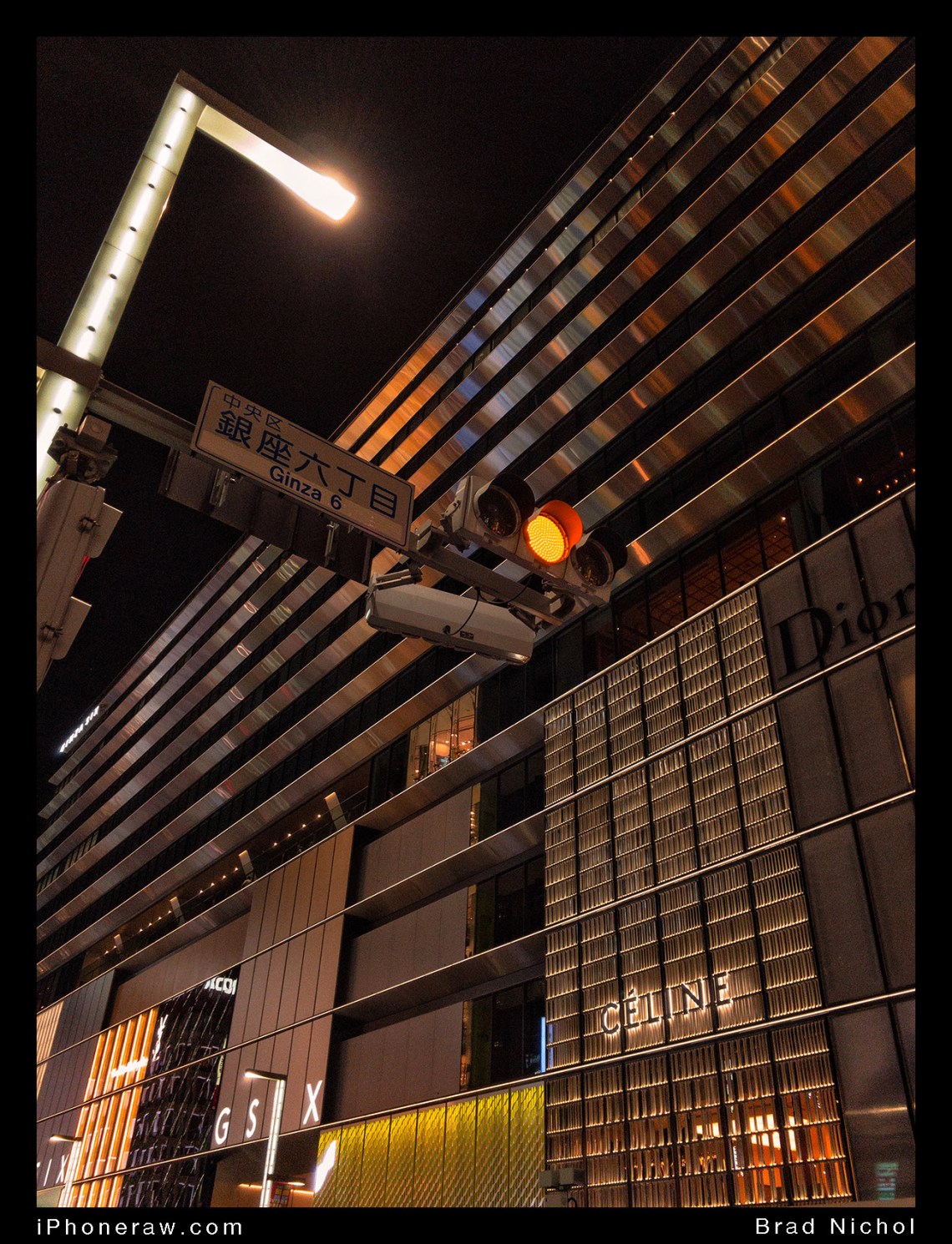 Modern buildings in Ginza strip, showing glass, stainless steel, acrylics and concrete. Taken at night, traffic light and ginza sign.