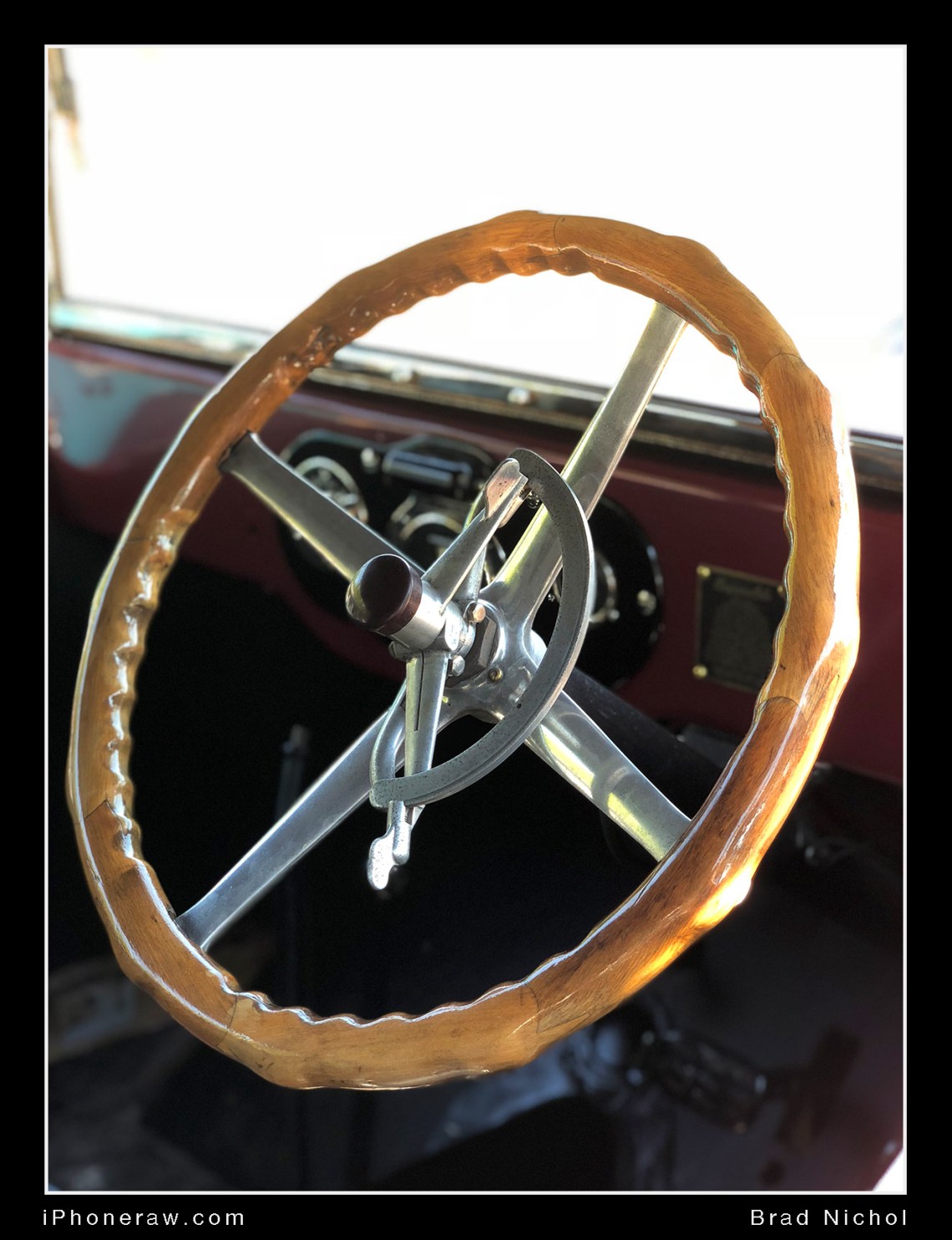 Photo of wooden steering wheel on vintage car taken with iPhone X portrait mode.